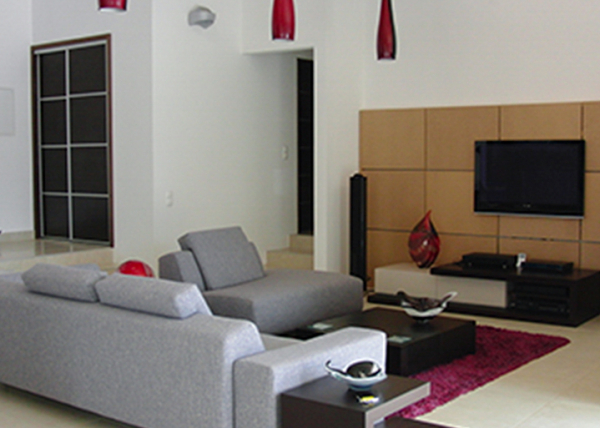 Lounge area with TV wall and wood burning fire.